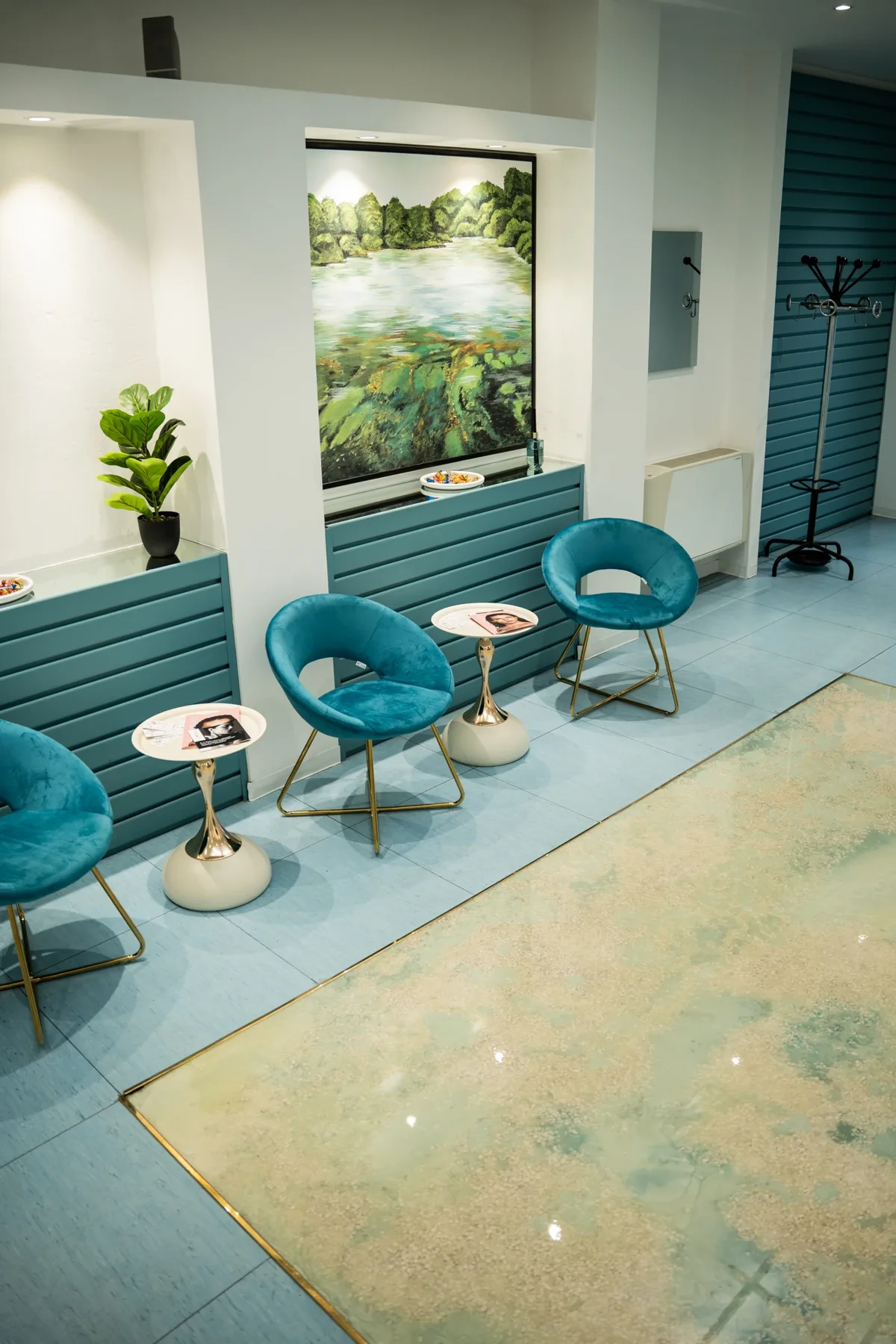 Sala d'attesa con poltroncine, tavolini e dipinto